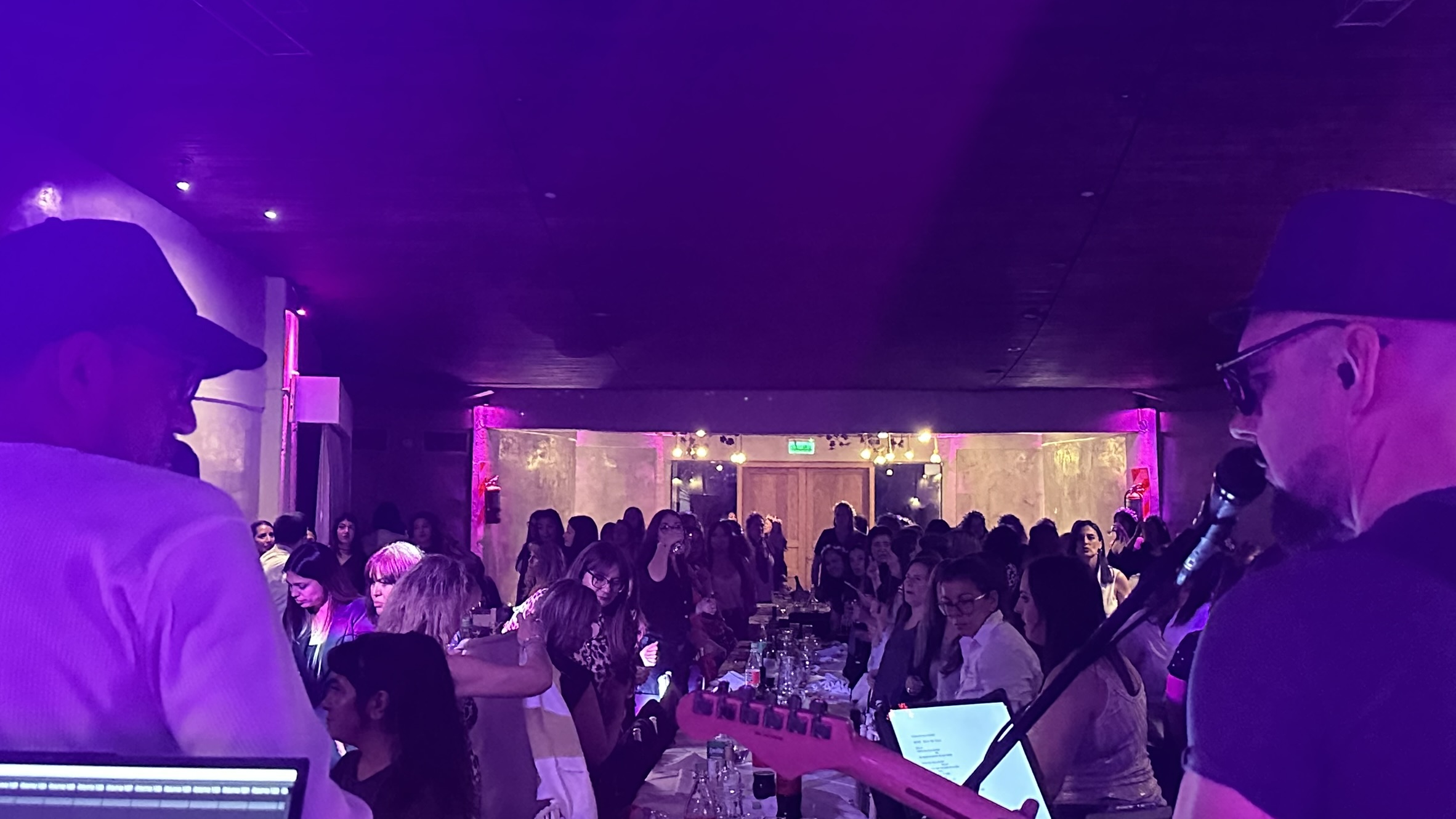 Vista desde el escenario hacia la pista llena en un salón de fiestas